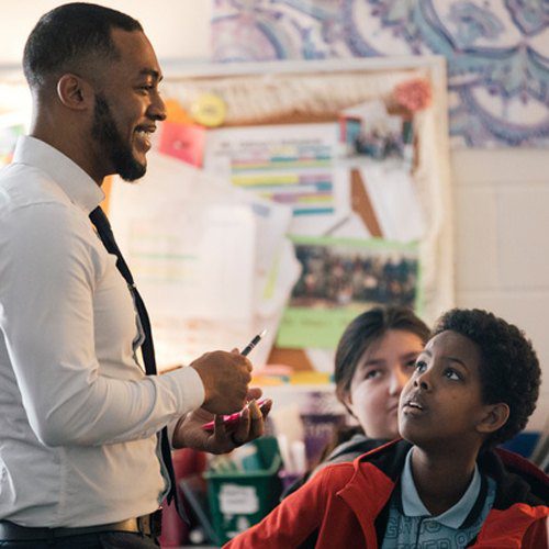 Teacher with two students listening