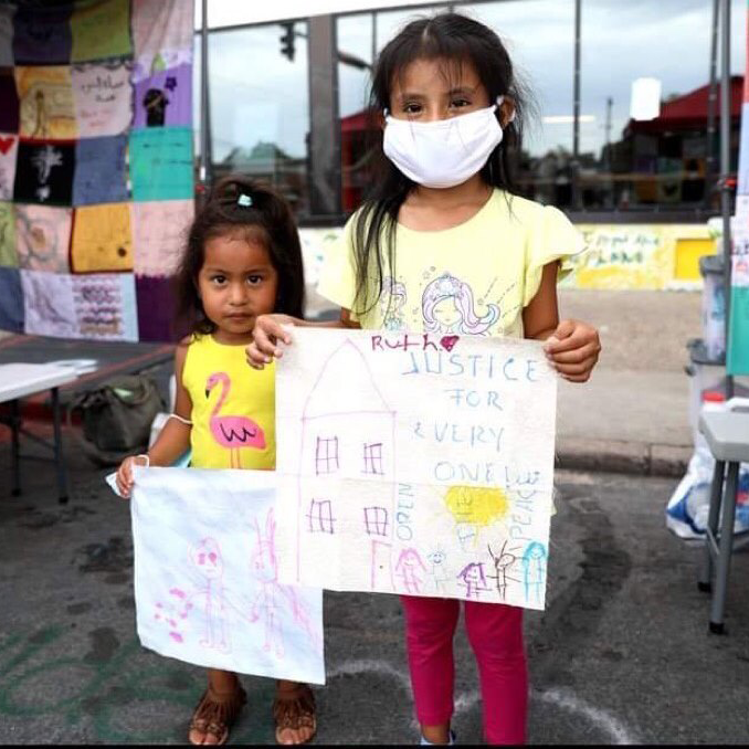 Two children holding signs
