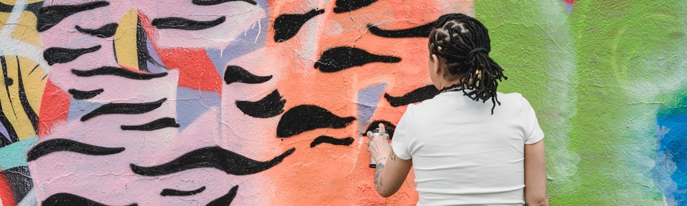 Person creating mural art