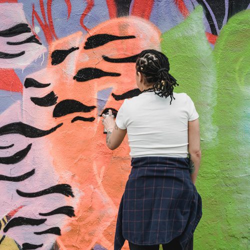 Person creating mural art