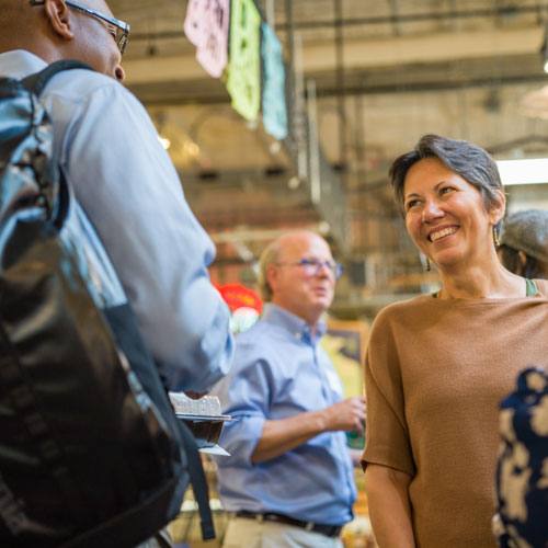 Two people having a conversation at the Midtown Global Market