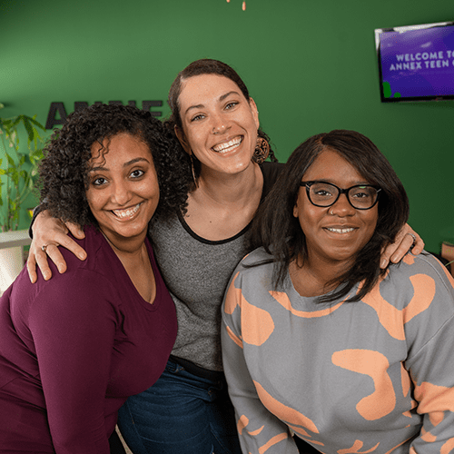 Three women smiline at the Annex Teen Clinic