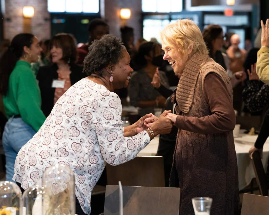 Two Minnesota Meeting attendees greeting each other