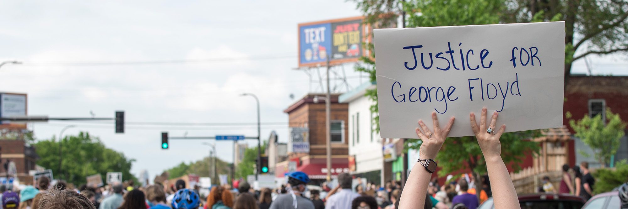 Person holding sign that says,