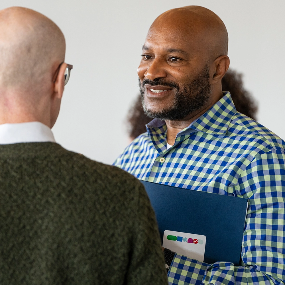 Two men talking to one another at an event