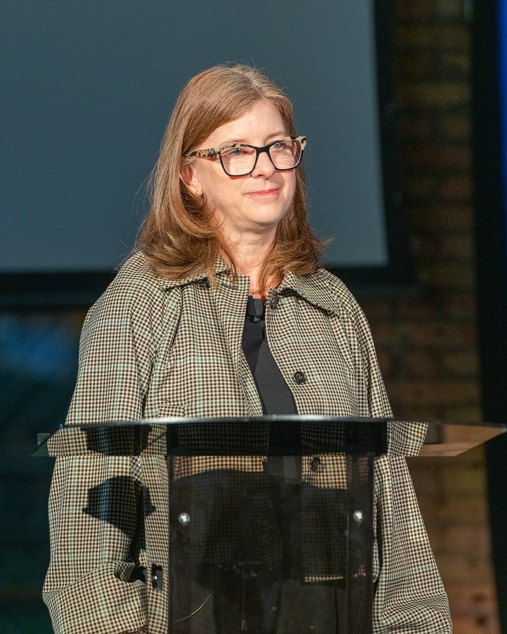 Laura Carlson speaking onstage