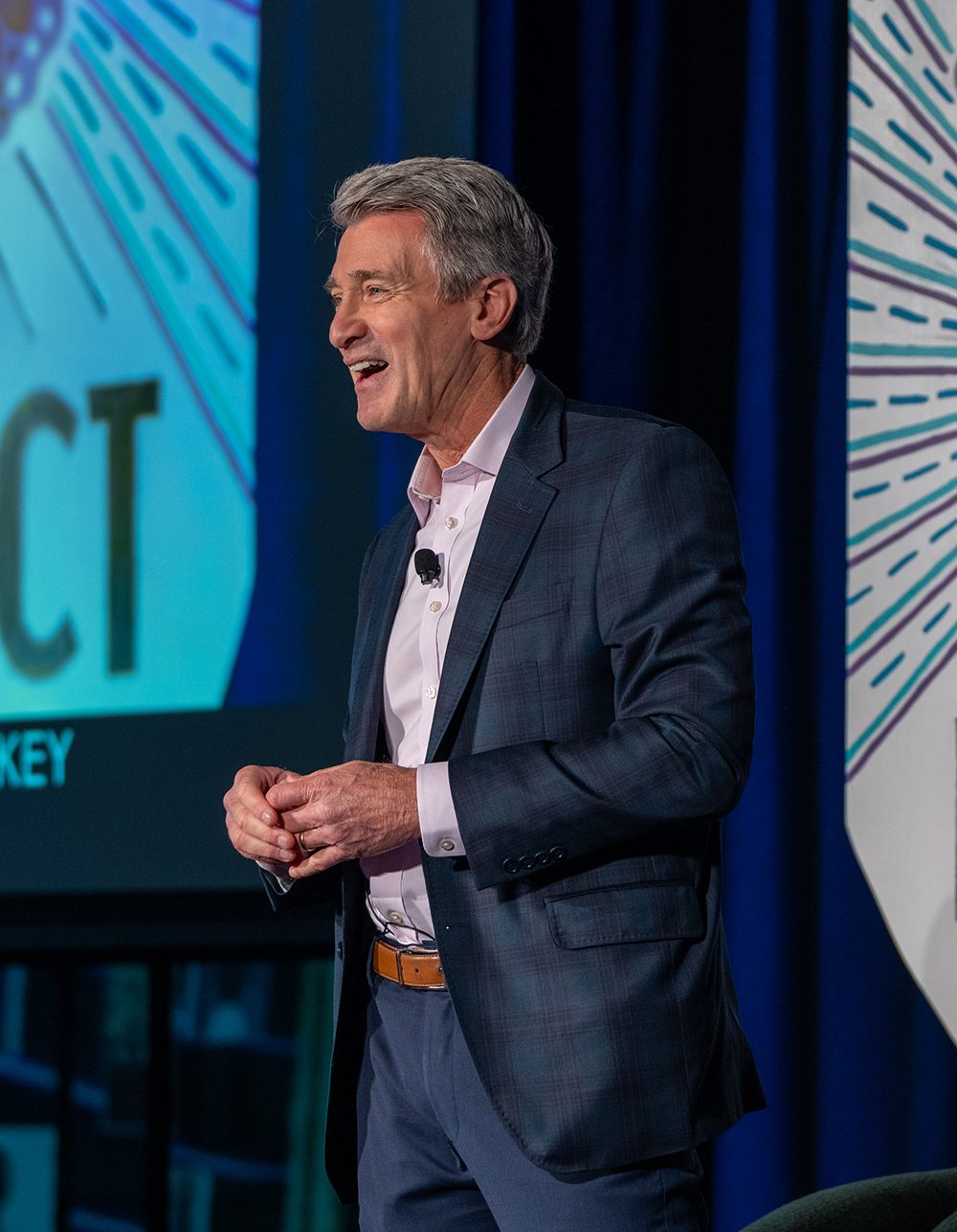R.T. Rybak speaking onstage and smiling.